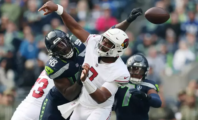 Seattle Seahawks linebacker Tyrice Knight (48) causes a fumble by Arizona Cardinals quarterback Jacoby Brissett, right, during the first half of an NFL football game Sunday, Nov. 9, 2025, in Seattle. (AP Photo/Maddy Grassy)