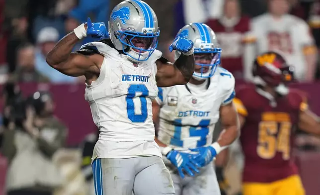 Detroit Lions running back Jahmyr Gibbs (0) celebrates after scoring during the first half of an NFL football game against the Washington Commanders Sunday, Nov. 9, 2025, in Landover, Md. (AP Photo/Stephanie Scarbrough)