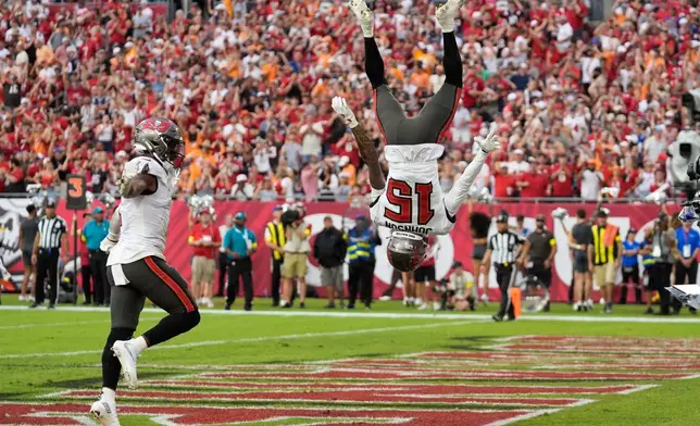 Tampa Bay Buccaneers wide receiver Tez Johnson (15) celebrates after scoring a touchdown against the the New England Patriots during the second half of an NFL football game Sunday, Nov. 9, 2025, in Tampa, Fla. (AP Photo/Chris O'Meara)