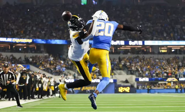 Los Angeles Chargers cornerback Cam Hart (20) breaks up a touchdown pass to Pittsburgh Steelers wide receiver DK Metcalf (4) during the second half of an NFL football game Sunday, Nov. 9, 2025, in Inglewood, Calif. (AP Photo/Jessie Alcheh)