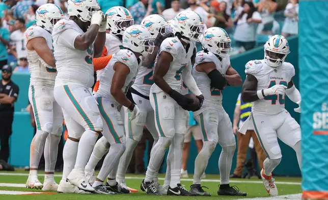 Miami Dolphins safety Ifeatu Melifonwu (9) celebrates an interception during the second half of an NFL football game against the Buffalo Bills, Sunday, Nov. 9, 2025, in Miami Gardens, Fla. (AP Photo/Lynne Sladky)