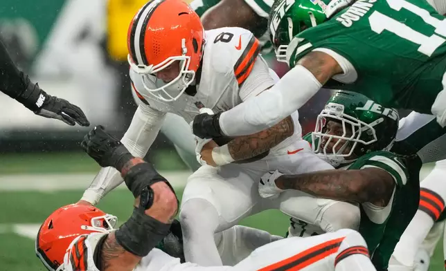 Cleveland Browns quarterback Dillon Gabriel (8) is sacked by New York Jets linebacker Quincy Williams in the second half of an NFL football game, Sunday, Nov. 9, 2025, in East Rutherford, N.J. (AP Photo/Yuki Iwamura)