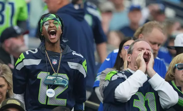 Seattle Seahawks fans shout as they watch the action on the field during the second half of an NFL football game against the Arizona Cardinals Sunday, Nov. 9, 2025, in Seattle. (AP Photo/Lindsey Wasson)