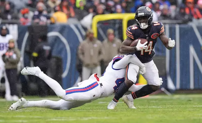 Chicago Bears wide receiver Olamide Zaccheaus (14) is tackled by New York Giants linebacker Zaire Barnes during the first half of an NFL football game Sunday, Nov. 9, 2025, in Chicago. (AP Photo/Nam Y. Huh)