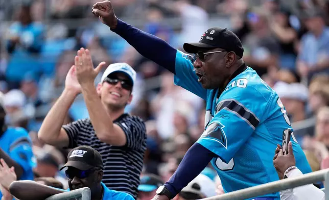 Carolina Panthers fans cheers during the second half of an NFL football game against the New Orleans Saints, Sunday, Nov. 9, 2025, in Charlotte, N.C. (AP Photo/Jacob Kupferman)