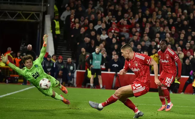 Nottingham Forest's Nikola Milenkovicshoot and score his sides third goal, which was given after a VAR review, during the Europa League opening phase soccer match between Nottingham Forest and Malmo in Nottingham, England, Thursday, Nov. 27, 2025. (AP Photo/Rui Vieira)