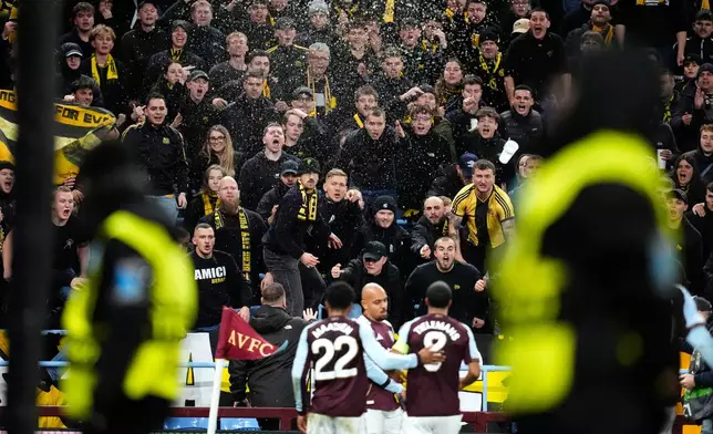 Young Boys' fans react as Aston Villa's Donyell Malen, center, celebrates after scoring the opening goal during the Europa League soccer match between Aston Villa and Young Boys in Birmingham, England, Thursday, Nov. 27, 2025. (Nick Potts/PA via AP)