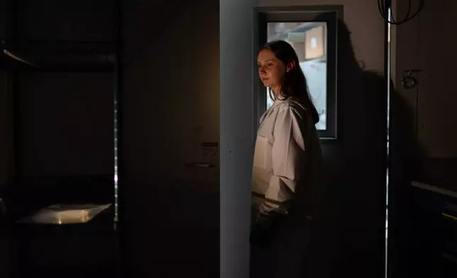 Researcher Abigail McGahan poses for a portrait in the warm room of a lab before she leaves E. coli bacteria incubating in a petri dish overnight for antibody production at Johns Hopkins University in Baltimore, Md., Tuesday, May 13, 2025. Most treatments for autoimmune diseases broadly suppress the immune system. McGahan is part of a team developing new options to target just rogue immune cells, not healthy ones. "I really enjoy the protein engineering aspect as in finding new tools to harness the immune system and this, I think, is, like, really close to having an impact in patients' lives." (AP Photo/David Goldman)