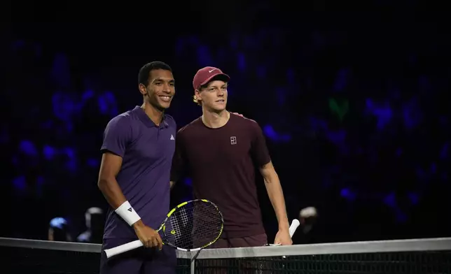 Canada's Felix Auger-Aliassime, left, and Italy's Jannik Sinner pose before the final match of the Paris Masters tennis tournament in Paris, Sunday, Nov. 2, 2025. (AP Photo/Christophe Ena)