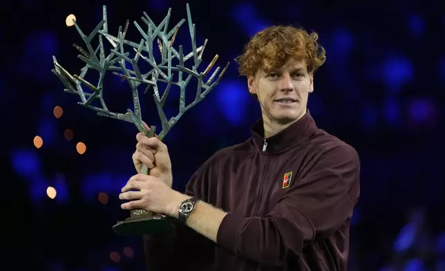 Italy's Jannik Sinner holds the trophy after winning the final match of the Paris Masters tennis tournament against Canada's Felix Auger-Aliassime in Paris, Sunday, Nov. 2, 2025. (AP Photo/Christophe Ena)