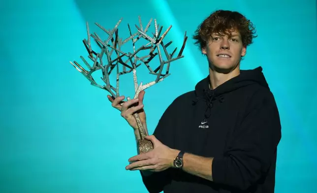 Italy's Jannik Sinner holds the trophy after winning the final match of the Paris Masters tennis tournament against Canada's Felix Auger-Aliassime in Paris, Sunday, Nov. 2, 2025. (AP Photo/Christophe Ena)