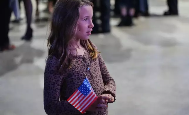 A young girl watches as election results come in during an election night watch party for Virginia Democratic gubernatorial candidate Abigail Spanberger Tuesday, Nov. 4, 2025, in Richmond, Va. (AP Photo/Stephanie Scarbrough)