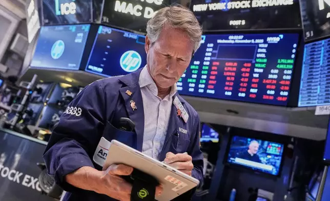 Trader Robert Charmak works on the floor of the New York Stock Exchange, Wednesday, Nov. 5, 2025. (AP Photo/Richard Drew)