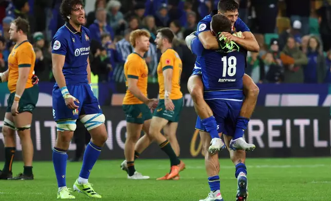 Italian players celebrate after winning the rugby union match between Italy and Australia in Udine, Italy, Saturday, Nov. 8, 2025. (Andrea Bressanutti/LaPresse via AP)