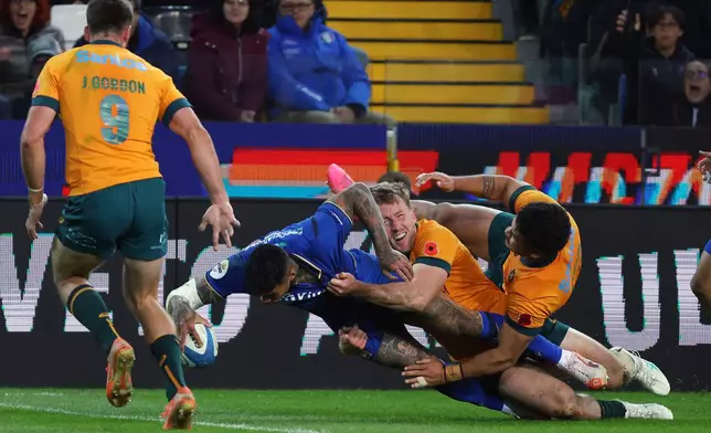 Australia's Monty Ioane scores a try during the rugby union match between Italy and Australia in Udine, Italy, Saturday, Nov. 8, 2025. (Andrea Bressanutti/LaPresse via AP)