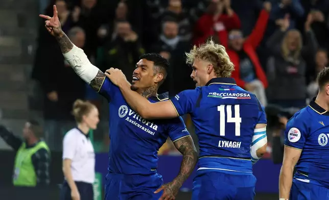 Italy's Monty Ioane, left, celebrates after scoring a try during the rugby union match between Italy and Australia in Udine, Italy, Saturday, Nov. 8, 2025. (Andrea Bressanutti/LaPresse via AP)