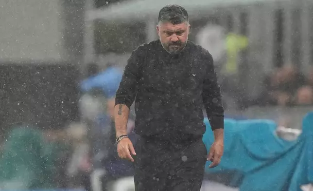 Italy's head coach Gennaro Gattuso walks under the rain before the start of the 2026 World Cup Group I qualifier soccer match between Italy and Norway in Milan, Italy, Sunday, Nov. 16, 2025. (AP Photo/Luca Bruno)