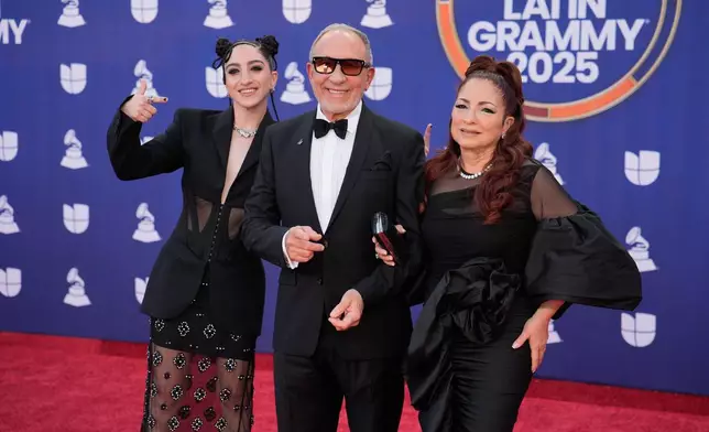 Emily Estefan, from left, Emilio Estefan, and Gloria Estefan arrive at the 2025 Latin Grammys on Thursday, Nov. 13, 2025, at MGM Grand in Las Vegas. (AP Photo/John Locher)
