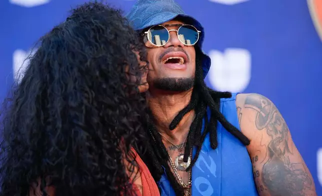 Yannely, left, and Vakero arrive at the 2025 Latin Grammys on Thursday, Nov. 13, 2025, at MGM Grand in Las Vegas. (AP Photo/John Locher)