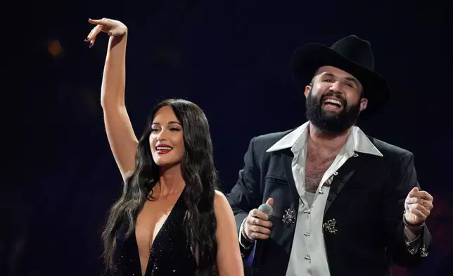Kacey Musgraves, left, and Carin Leon perform during the 2025 Latin Grammys on Thursday, Nov. 13, 2025, at MGM Grand in Las Vegas. (AP Photo/Chris Pizzello)