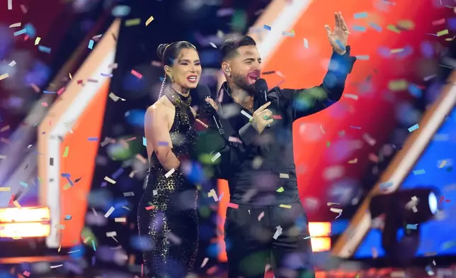 Hosts Roselyn Sanchez and Maluma appear on stage at the conclusion of the 2025 Latin Grammys on Thursday, Nov. 13, 2025, at MGM Grand in Las Vegas. (AP Photo/Chris Pizzello)