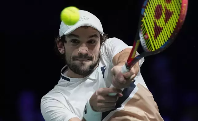 Monaco's Valentin Vacherot returns to Canada's Felix Auger-Aliassime during their quarterfinal match of the Paris Masters tennis tournament in Paris, Friday, Oct. 31, 2025. (AP Photo/Christophe Ena)