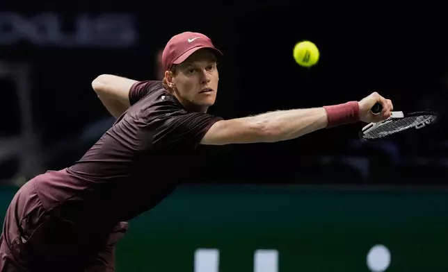 Italy's Jannik Sinner returns to Ben Shelton of the United States during a quarterfinal match of the Paris Masters tennis tournament in Paris, Friday, Oct. 31, 2025.((AP Photo/Michel Euler)