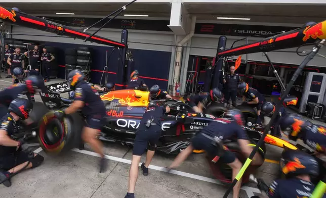 Team members of Red Bull driver Max Verstappen, of the Netherlands, practice pit stops at the Interlagos race track ahead of the Brazilian Formula One Grand Prix in Sao Paulo, Thursday, Nov. 6, 2025. (AP Photo/Andre Penner)