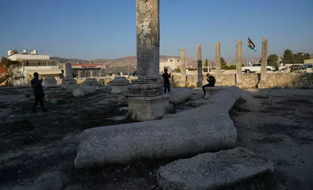 Palestinians visit the Roman historical site in the West Bank town of Sebastia Thursday, Nov. 20, 2025. (AP Photo/Nasser Nasser)