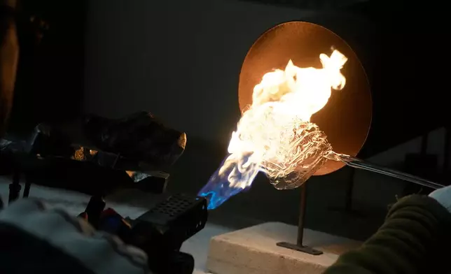 A worker prepares a hand-made Christmas bauble at GlitterLab in Czestochowa, southern Poland, on Nov. 21, 2025. (AP Photo/Czarek Sokolowski)