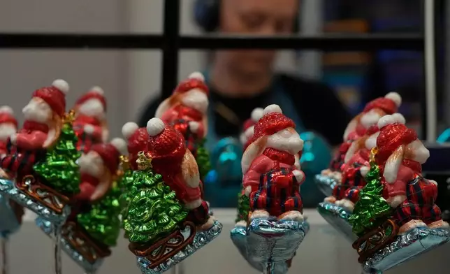 A worker prepares the hand-made Christmas baubles at GlitterLab in Czestochowa, southern Poland, on Nov. 21, 2025. (AP Photo/Czarek Sokolowski)