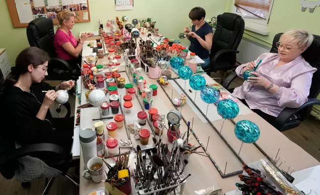 Workers prepare the hand-made Christmas baubles at GlitterLab in Czestochowa, southern Poland, on Nov. 21, 2025. (AP Photo/Czarek Sokolowski)