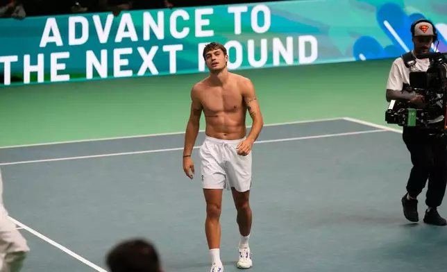 Italy's Flavio Cobolli celebrates after winning against Belgium's Zizou Bergs during a Davis Cup singles semifinal match between Italy and Belgium, in Bologna, Italy, Friday, Nov. 21, 2025. (AP Photo/Luca Bruno)