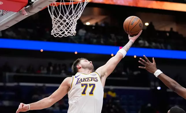 Los Angeles Lakers guard Luka Doncic (77) leaps for a rebound against the New Orleans Pelicans in the first half of an NBA Cup basketball game, Friday, Nov. 14, 2025, in New Orleans. (AP Photo/Gerald Herbert)