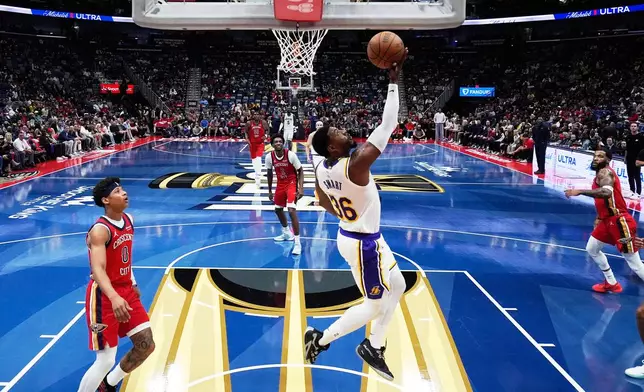 Los Angeles Lakers guard Marcus Smart (36) goes to the basket past New Orleans Pelicans guard Jeremiah Fears (0) in the first half of an NBA Cup basketball game, Friday, Nov. 14, 2025, in New Orleans. (AP Photo/Gerald Herbert)