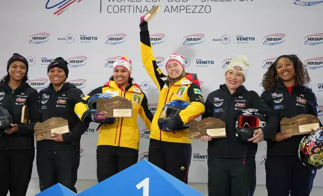 Second placed Kaysha Love and Azaria Hill, of the United States, winners Laura Nolte and Deborah Levi, of Germany, and third placed Kaillie Armbruster Humphries and Sylvia Hoffman, of the United States, pose on the podium of the 2-woman bobsleigh World Cup and Olympic test event in Cortina D'Ampezzo, Italy, Sunday, Nov. 23, 2025. (AP Photo/Andrew Medichini)