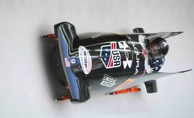Kaysha Love and Azaria Hill, of the United States, race down the course during the 2-woman bobsleigh World Cup and Olympic test event in Cortina D'Ampezzo, Italy, Sunday, Nov. 23, 2025. (AP Photo/Andrew Medichini)