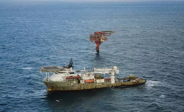 The Nini oil field and a vessel are seen from a helicopter above the North Sea, Denmark, Tuesday, Nov. 25, 2025. (AP Photo/James Brooks)
