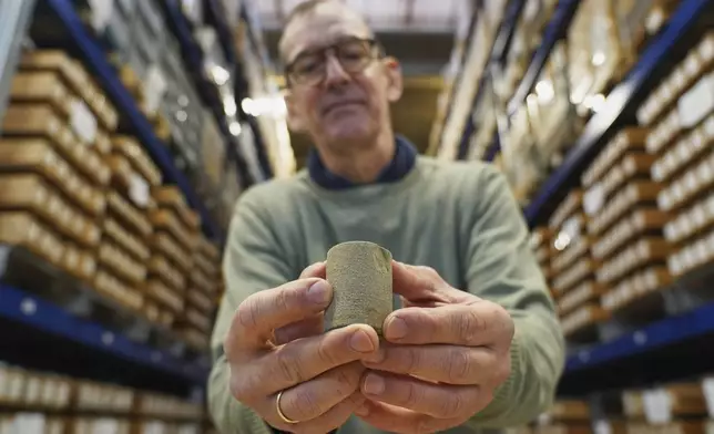 Niels Schovsbo, a senior researcher at the Geological Survey of Denmark and Greenland (GEUS), holds a Greensand reservoir rock core sample at a GEUS facility in Taastrup, Denmark, Monday, Nov. 24, 2025. (AP Photo/James Brooks)