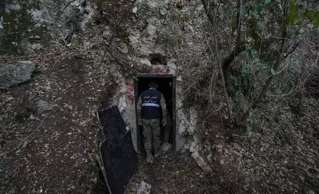 A Lebanese army soldier stands at the entrance of a tunnel dug into a mountain that was used by Hezbollah militants as a clinic and storage facility near the Lebanese-Israeli border in the Zibqin Valley, southern Lebanon, Friday, Nov. 28, 2025. (AP Photo/Bilal Hussein)