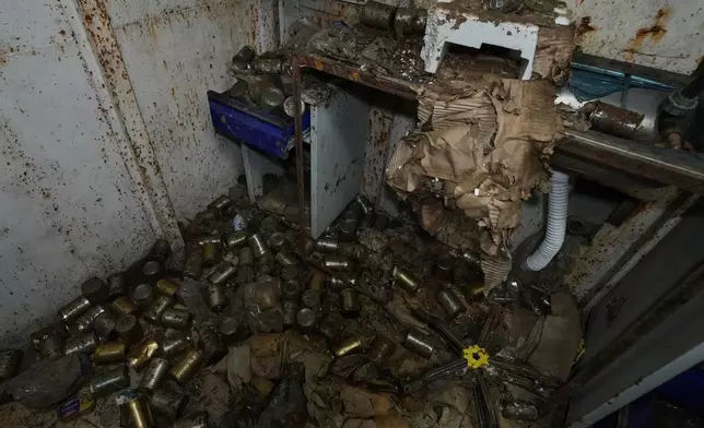 Boxes of canned food are scattered inside one of the rooms of the tunnel dug into a mountain that was used by Hezbollah militants as a clinic and storage facility, near the Lebanese-Israeli border in the Zibqin Valley, southern Lebanon, Friday, Nov. 28, 2025. (AP Photo/Bilal Hussein)