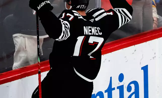 New Jersey Devils defenseman Simon Nemec (17) celebrates after scoring the game winning goal during overtime of an NHL hockey game against the St. Louis Blues, Wednesday, Nov. 26, 2025, in Newark, N.J. (AP Photo/Noah K. Murray)