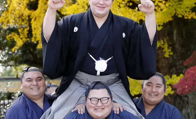 Ukrainian sumo wrestler Aonishiki, top, poses as he celebrates his promotion to the rank of ozeki in Kurume, Fukuoka prefecture, southern Japan Wednesday, Nov. 26, 2025. (Kyodo News via AP)