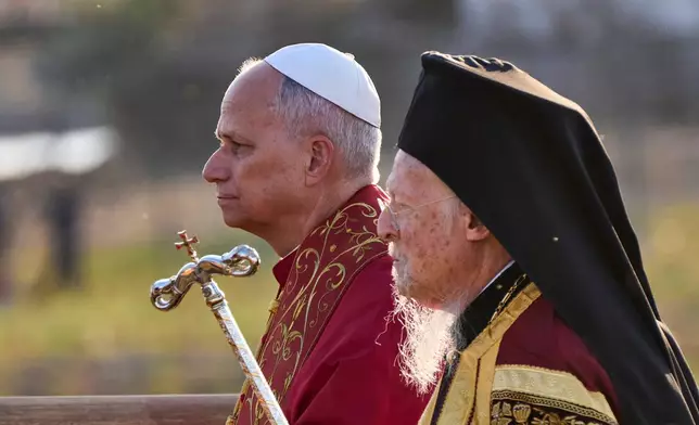 Pope Leo XIV and Ecumenical Patriarch Bartholomew I, right, leave at the end of an Ecumenical prayer service near the archaeological site of the ancient Basilica of Saint Neophytos in Iznik, Turkey, on Friday, November 28, 2025. (AP Photo/Domenico Stinellis)