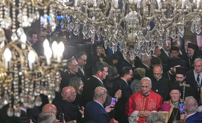 Pope Leo XIV, bottom second from right, walks with Ecumenical Patriarch Bartholomew I prior to the start of the Doxology in the Patriarchal Church of Saint George in Istanbul, Turkey, Saturday, Nov. 29, 2025. (AP Photo/Domenico Stinellis)