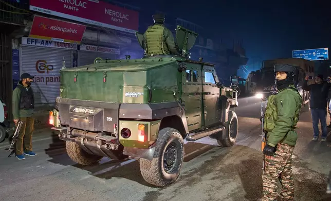 Indian security forces stand near the site of an explosion inside a police station in Srinagar, Indian controlled Kashmir, Friday, Nov. 14, 2025. (AP Photo/Yasin Dar)