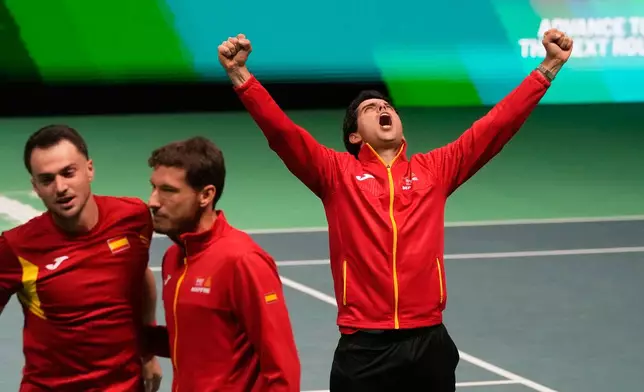 Spain's Marcel Granollers and Pedro Martinez celebrate with their teammates after winning against Germany's Kevin Krawietz and Tim Puetz during a Davis Cup double semifinal tennis match between Spain and Germany, in Bologna, Italy, Saturday, Nov. 22, 2025. (AP Photo/Luca Bruno)