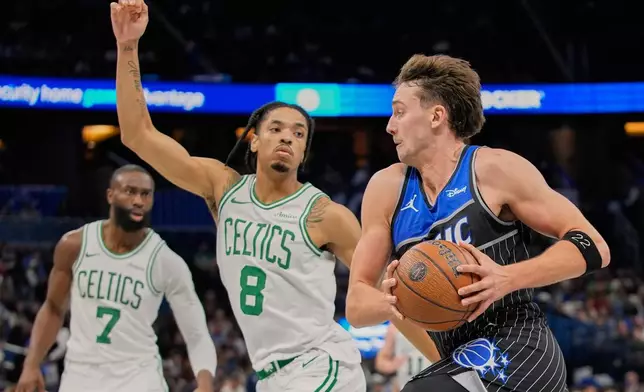 Orlando Magic forward Franz Wagner, right, drives past Boston Celtics forward Josh Minott (8) during the second half of an NBA Cup basketball game, Friday, Nov. 7, 2025, in Orlando, Fla. (AP Photo/John Raoux)