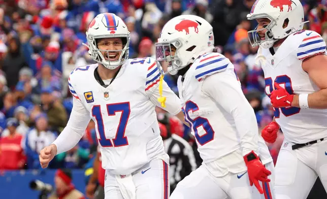 Buffalo Bills quarterback Josh Allen (17) celebrates with tight end Dawson Knox, right, after a touchdown by running back Ty Johnson, center, against the Tampa Bay Buccaneers during the first half of an NFL football game, Sunday, Nov. 16, 2025, in Orchard Park, N.Y. (AP Photo/Jeffrey T. Barnes)