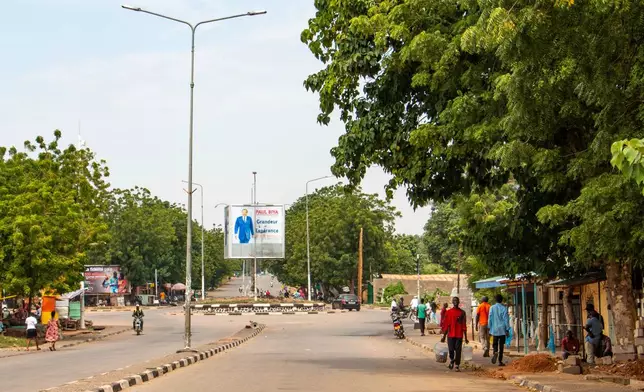People walk on the empty streets of Garoua, northern Cameroon, Tuesday, Nov. 4, 2025. (AP Photo/Pascal Welba Yamo )